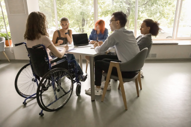 A group of young students discuss issues at a table