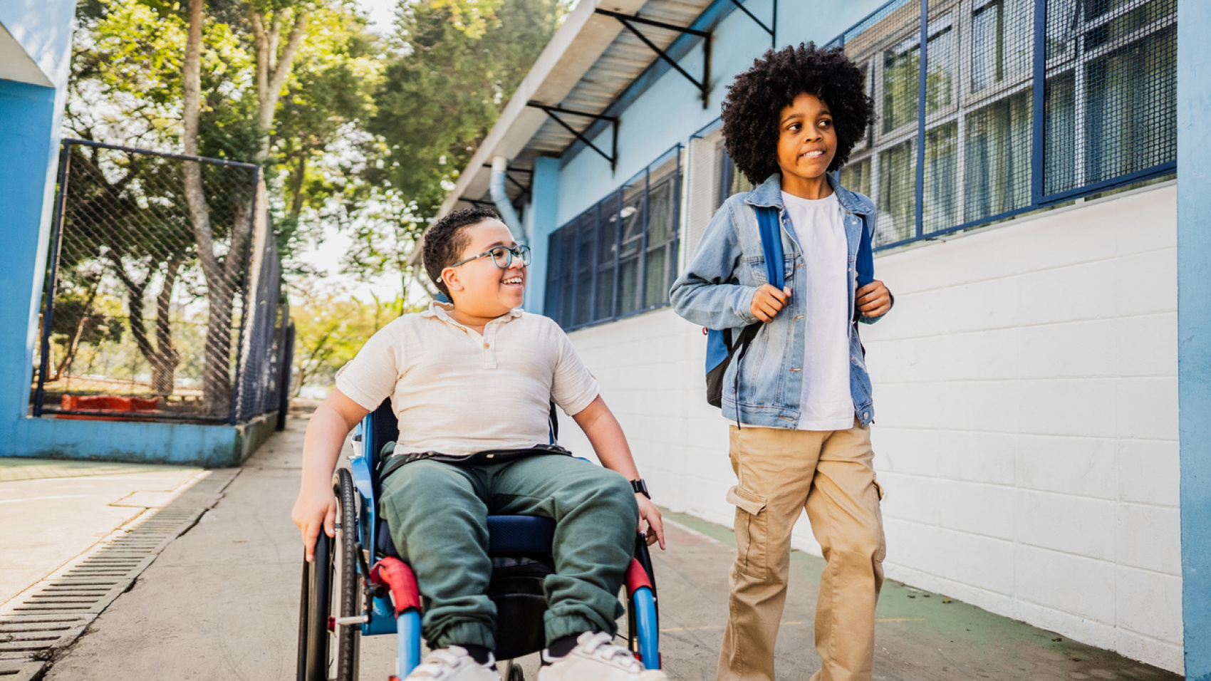 Boy in wheelchair with friend outside school
