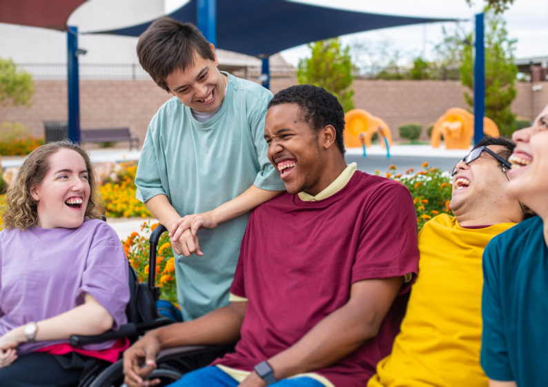 Five young people laughing