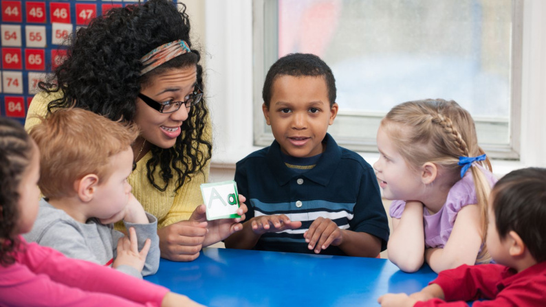 children sat engaged talking to adullt